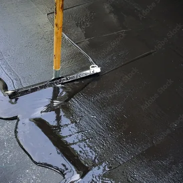 Fresh sealcoat being applied